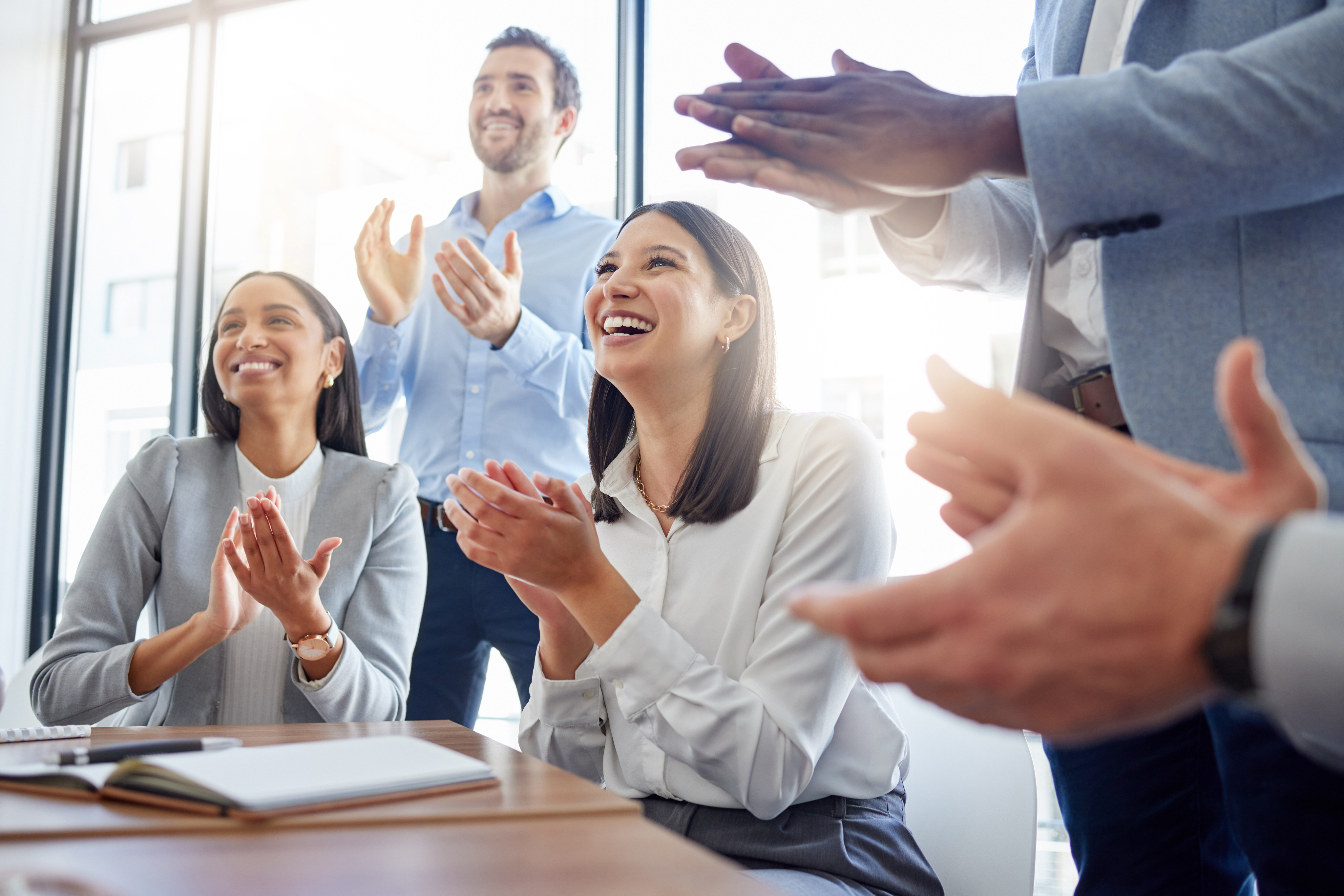 people in an office smiling and clapping